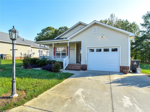 single story home featuring a front lawn, driveway, a porch, and a garage