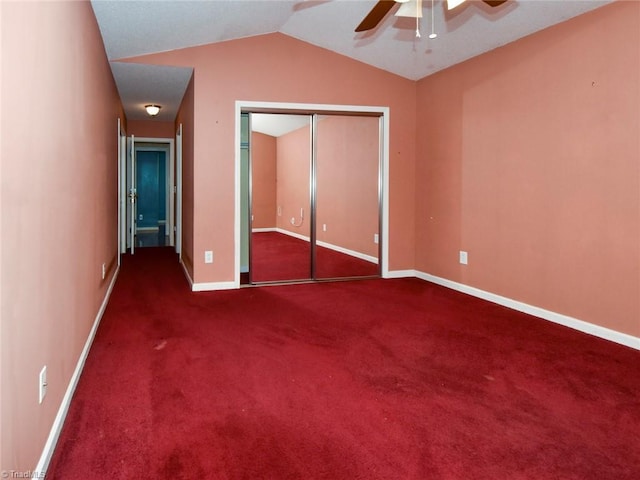 unfurnished bedroom featuring lofted ceiling, carpet, a ceiling fan, a closet, and baseboards
