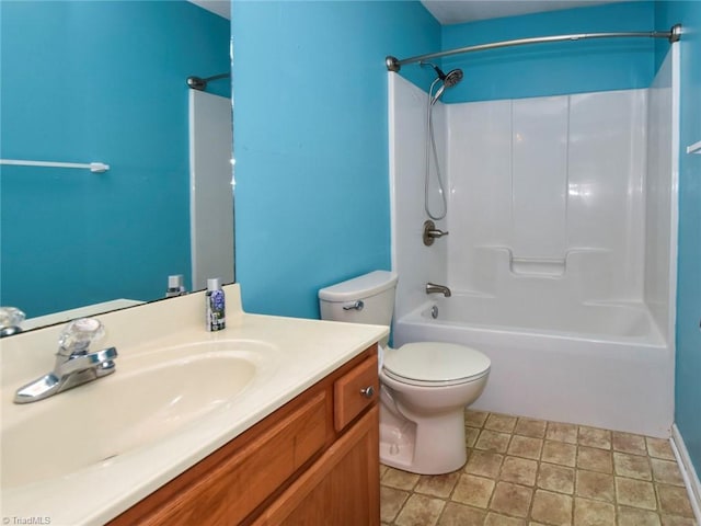 bathroom featuring stone finish flooring, toilet, vanity, and  shower combination