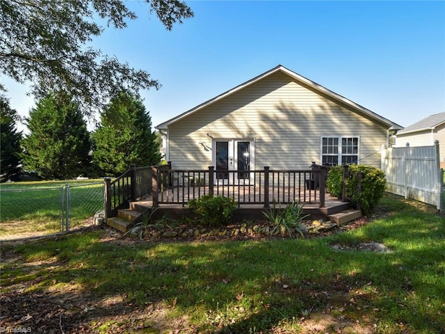 rear view of property featuring a yard and a deck