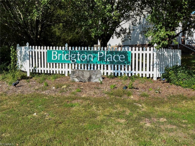 community sign featuring fence