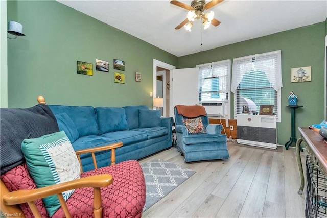 living room featuring ceiling fan and light hardwood / wood-style floors