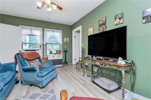 living room with ceiling fan and light hardwood / wood-style flooring