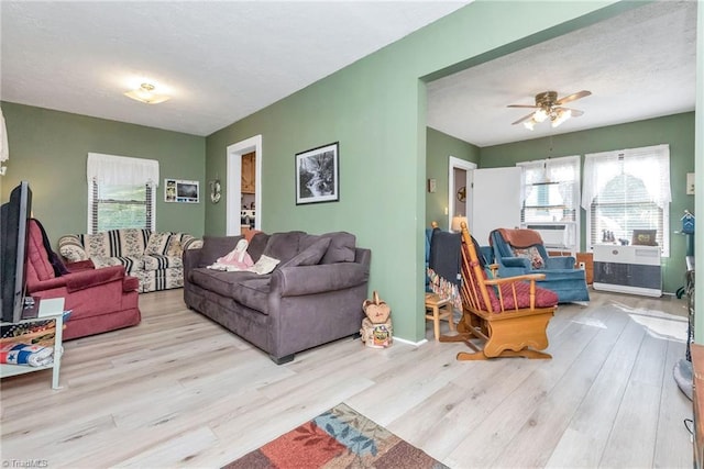 living room featuring light hardwood / wood-style floors and ceiling fan