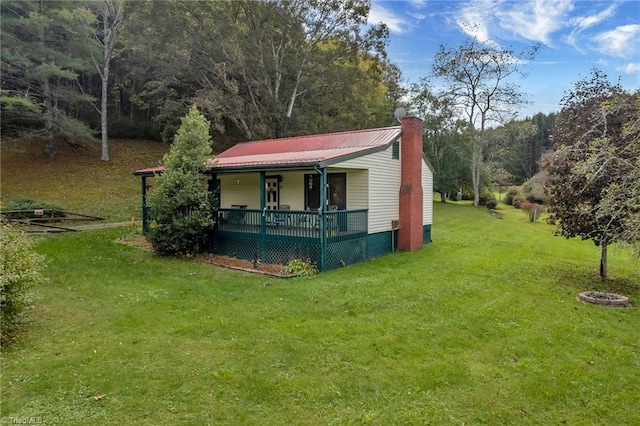 exterior space featuring a porch and a yard