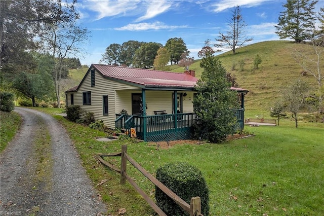 view of property exterior featuring covered porch and a yard