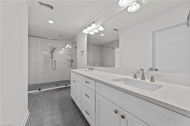 bathroom featuring a sink, tiled shower, ornamental molding, and double vanity