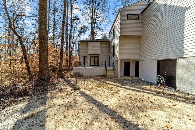 rear view of property featuring brick siding