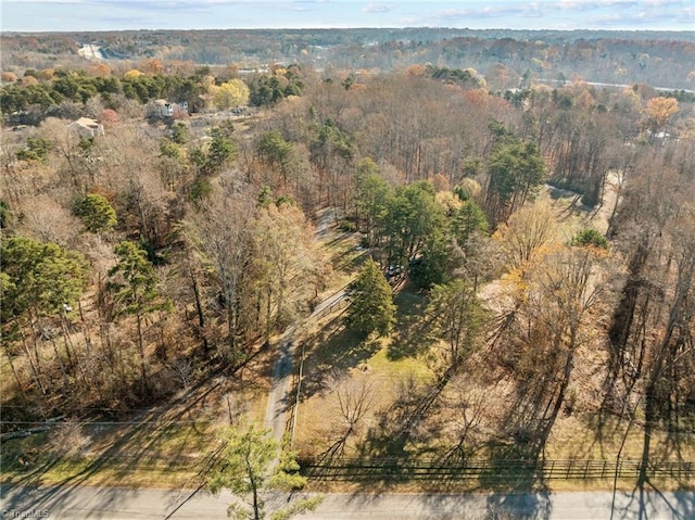 birds eye view of property with a forest view