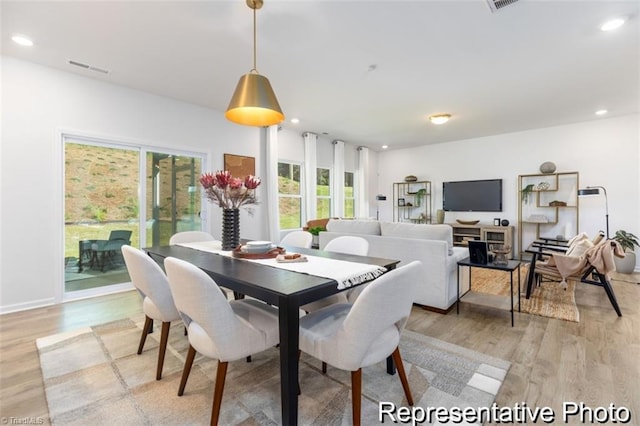 dining room with light wood-style flooring, visible vents, and recessed lighting