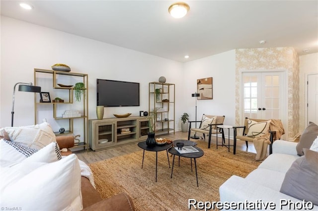 living room with french doors, light wood-style flooring, and recessed lighting