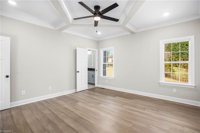 unfurnished bedroom featuring ceiling fan, light hardwood / wood-style flooring, crown molding, and coffered ceiling