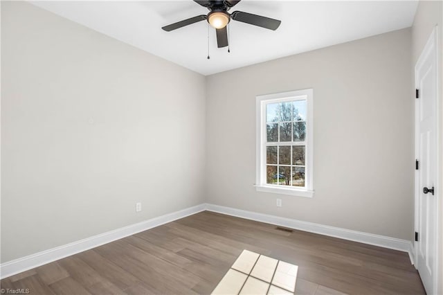 spare room with hardwood / wood-style flooring and ceiling fan