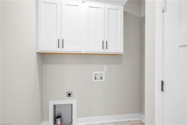 washroom featuring cabinets, light tile patterned floors, washer hookup, and hookup for an electric dryer