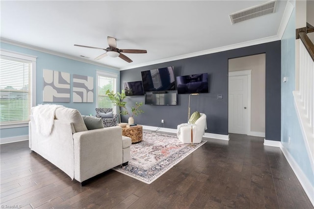 living area with ceiling fan, ornamental molding, baseboards, visible vents, and dark wood-style floors