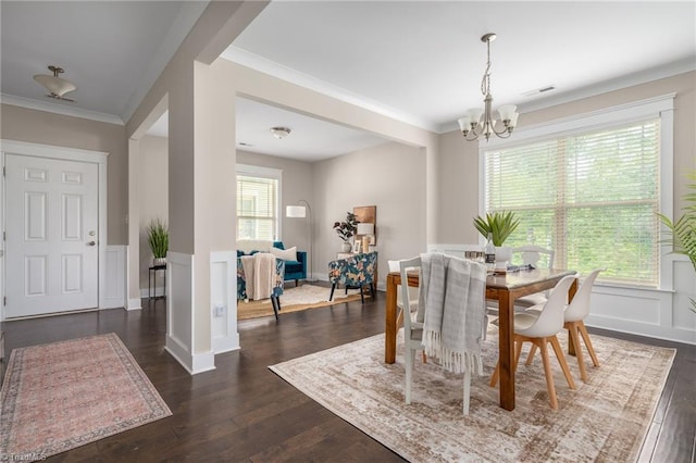 dining space featuring a wealth of natural light, a notable chandelier, dark wood-style flooring, and visible vents