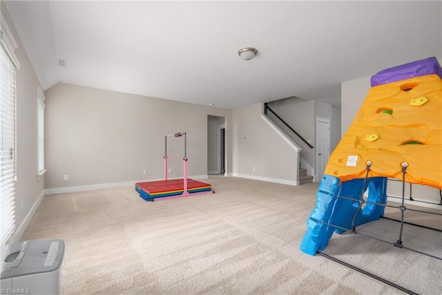 rec room featuring baseboards, carpet, and lofted ceiling