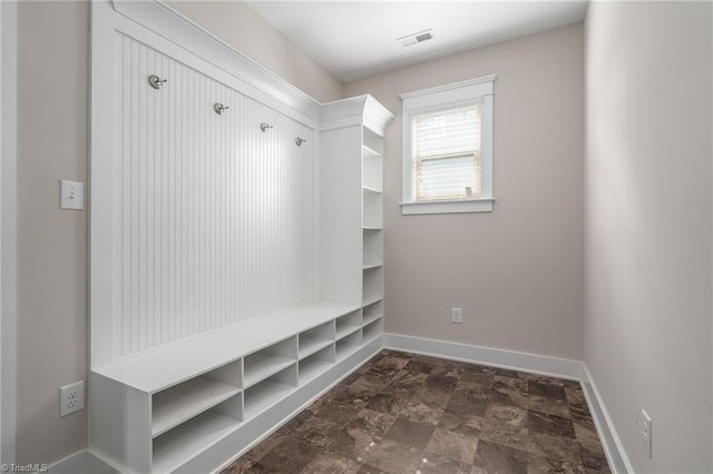 mudroom featuring visible vents, stone finish flooring, and baseboards