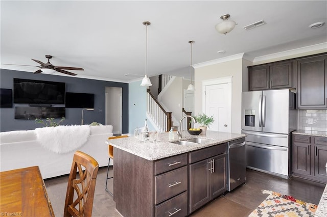 kitchen with visible vents, a sink, appliances with stainless steel finishes, and ornamental molding