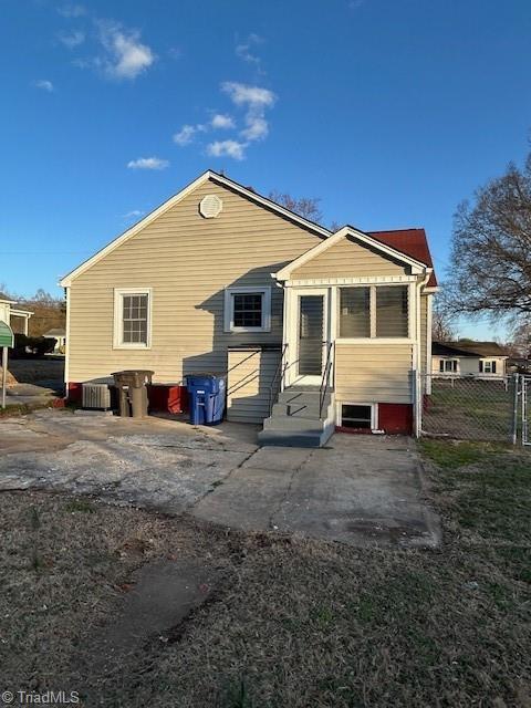 back of house featuring fence and entry steps