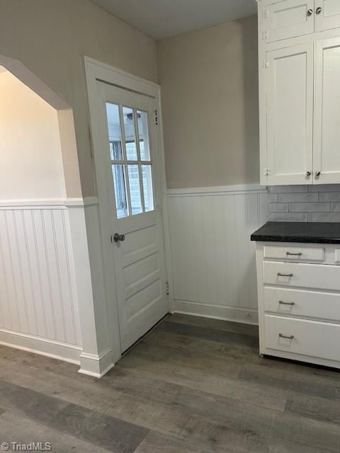 entryway featuring wainscoting and dark wood-style flooring