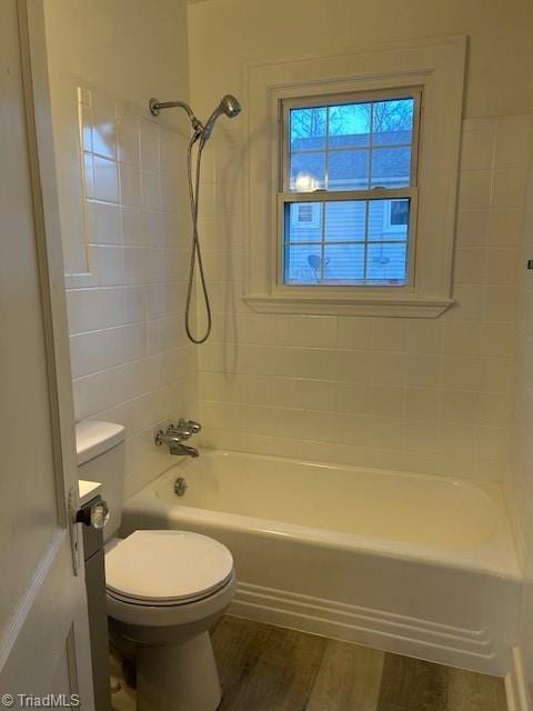 bathroom featuring shower / bath combination, toilet, and wood finished floors