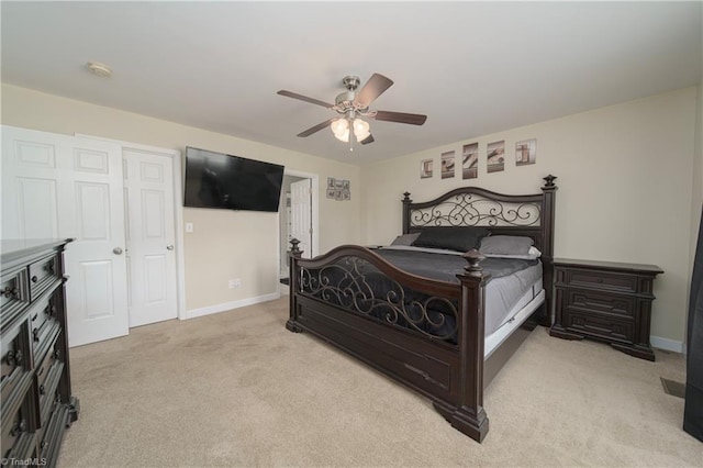 bedroom with ceiling fan and light carpet