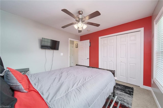 bedroom with a closet, ceiling fan, and carpet flooring