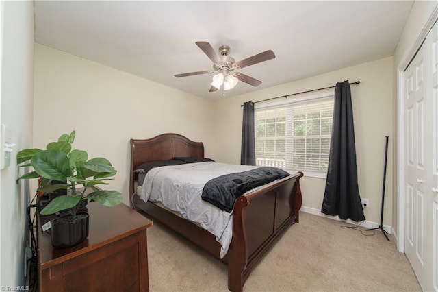 carpeted bedroom featuring ceiling fan and a closet