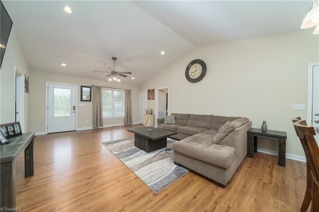 living room with light wood-type flooring, vaulted ceiling, and ceiling fan