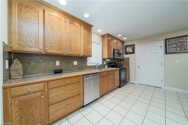 kitchen featuring decorative backsplash, appliances with stainless steel finishes, light tile patterned floors, and sink