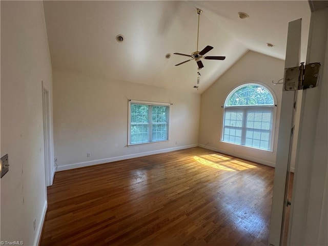 empty room featuring lofted ceiling, dark hardwood / wood-style flooring, and ceiling fan