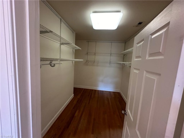 spacious closet with dark hardwood / wood-style floors