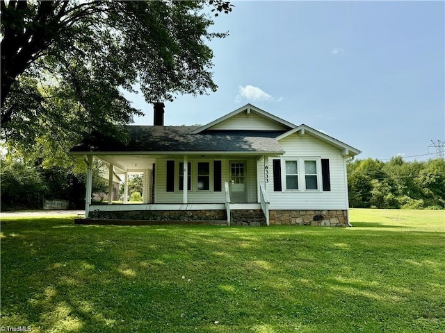 view of front of home with a porch and a front yard