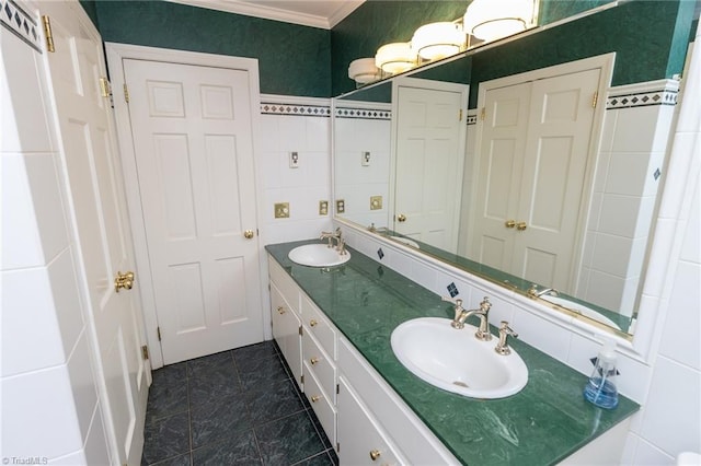 bathroom with crown molding, vanity, and tile walls