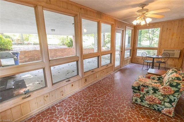 sunroom / solarium with ceiling fan and a wall mounted AC