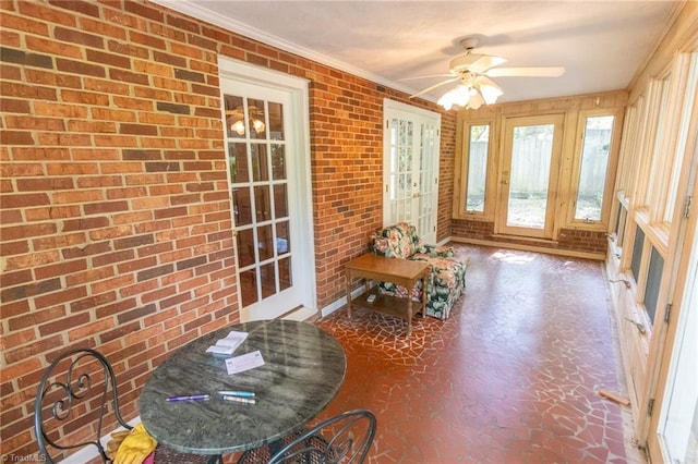 sunroom / solarium featuring ceiling fan