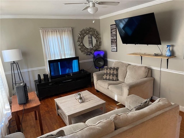 living room featuring baseboards, crown molding, ceiling fan, and wood finished floors