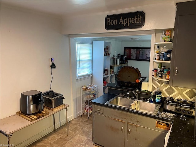 kitchen with a sink and dark countertops