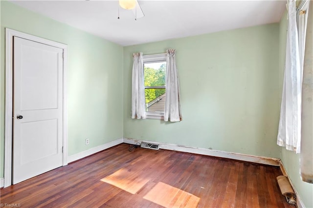 spare room with wood finished floors, baseboards, and ceiling fan