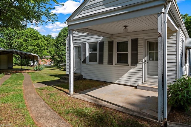 view of property exterior featuring entry steps, a lawn, and a carport