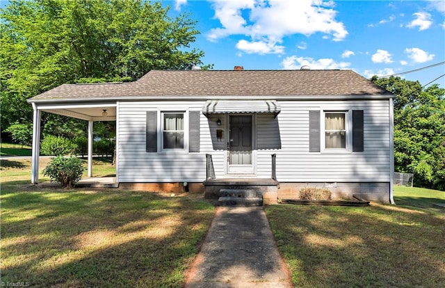 bungalow-style home featuring a front yard and a shingled roof