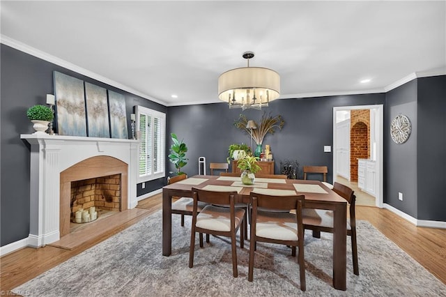 1901 Runnymede Rd, Winston-Salem, NC 27104 - dining space featuring crown molding, wood finished floors, recessed lighting, a chandelier, and a fireplace with flush hearth