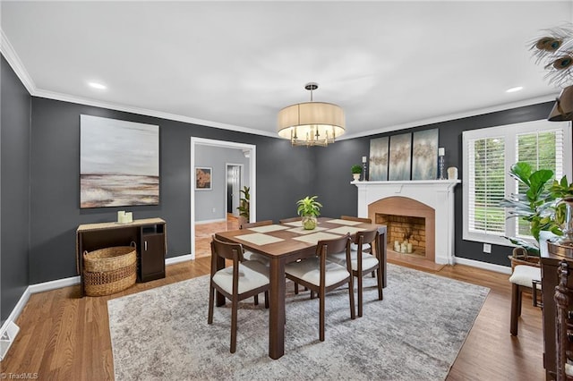 1901 Runnymede Rd, Winston-Salem, NC 27104 - dining room with crown molding, wood finished floors, a chandelier, and a fireplace