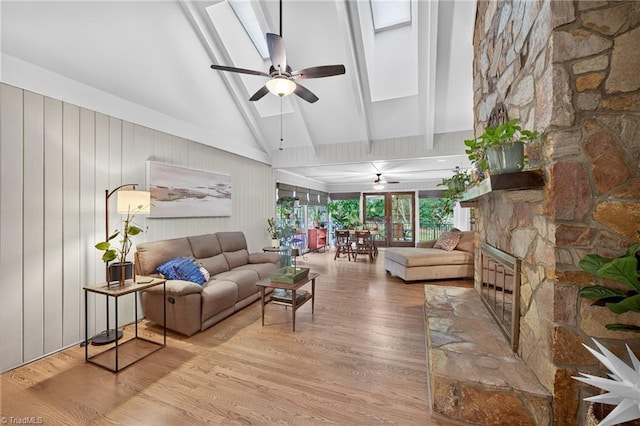 1901 Runnymede Rd, Winston-Salem, NC 27104 - living room with ceiling fan, wood finished floors, a skylight, and a stone fireplace