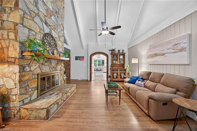 1901 Runnymede Rd, Winston-Salem, NC 27104 - living room with a ceiling fan, wood finished floors, a fireplace, and arched walkways