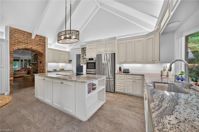 1901 Runnymede Rd, Winston-Salem, NC 27104 - kitchen with open shelves, stainless steel fridge, arched walkways, beam ceiling, and a center island