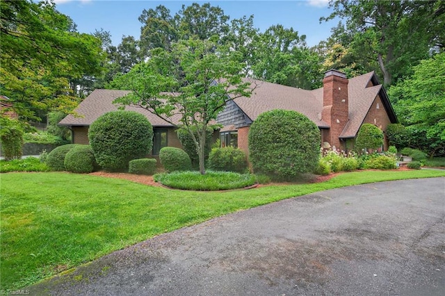1901 Runnymede Rd, Winston-Salem, NC 27104 - view of front of home with a front yard, a chimney, and brick siding
