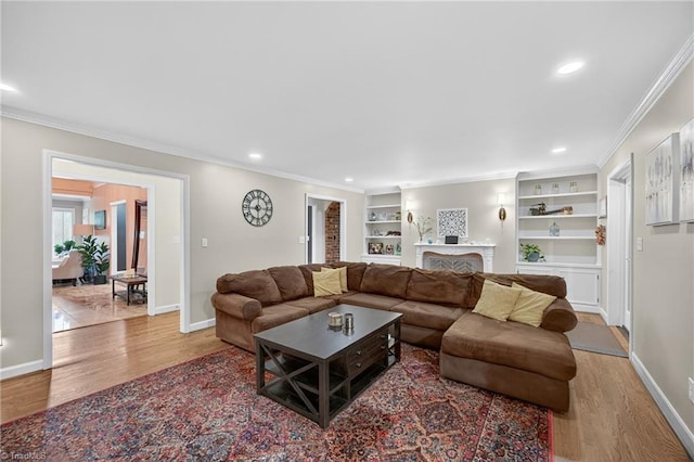 1901 Runnymede Rd, Winston-Salem, NC 27104 - living room with wood finished floors, ornamental molding, recessed lighting, a fireplace, and built in shelves