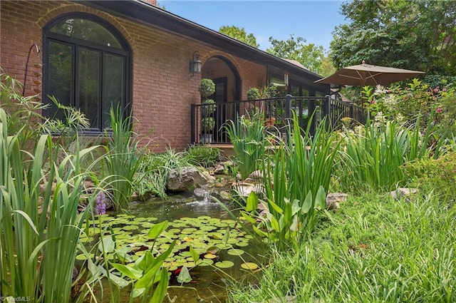 1901 Runnymede Rd, Winston-Salem, NC 27104 - view of exterior entry featuring brick siding and a small pond